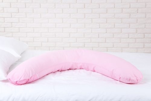 Pink Body Pillow on a White Bed
