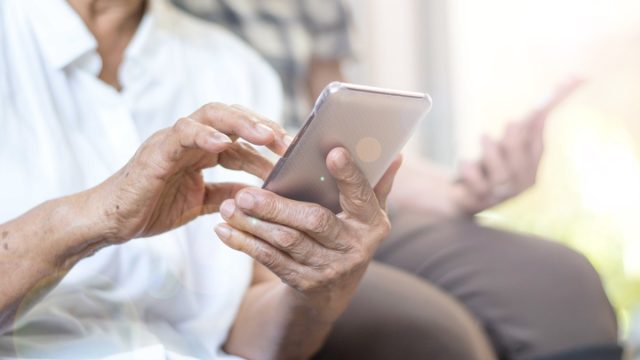 older person using cell phone