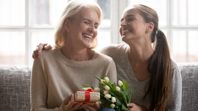 older mother getting gift from daughter