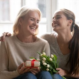 older mother getting gift from daughter