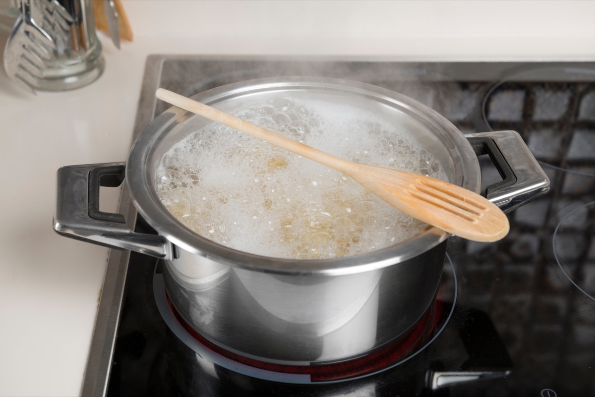 Wooden Spoon on Top of Boiling Pot of Water