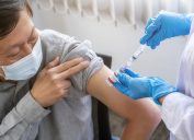 Doctor injecting Covid-19 coronavirus vaccine for older man