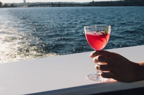 Hand Holding a Pink Cocktail on a Cruise Ship