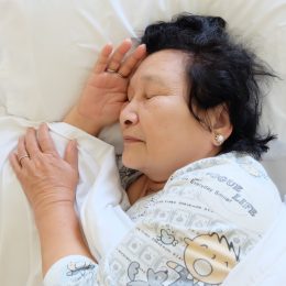 older woman sleeping in bed