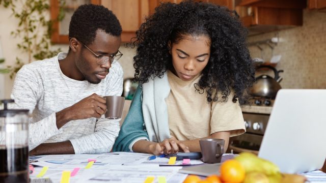 couple calculating taxes in kitchen