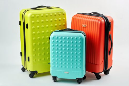 Three Brightly Colored Suitcases
