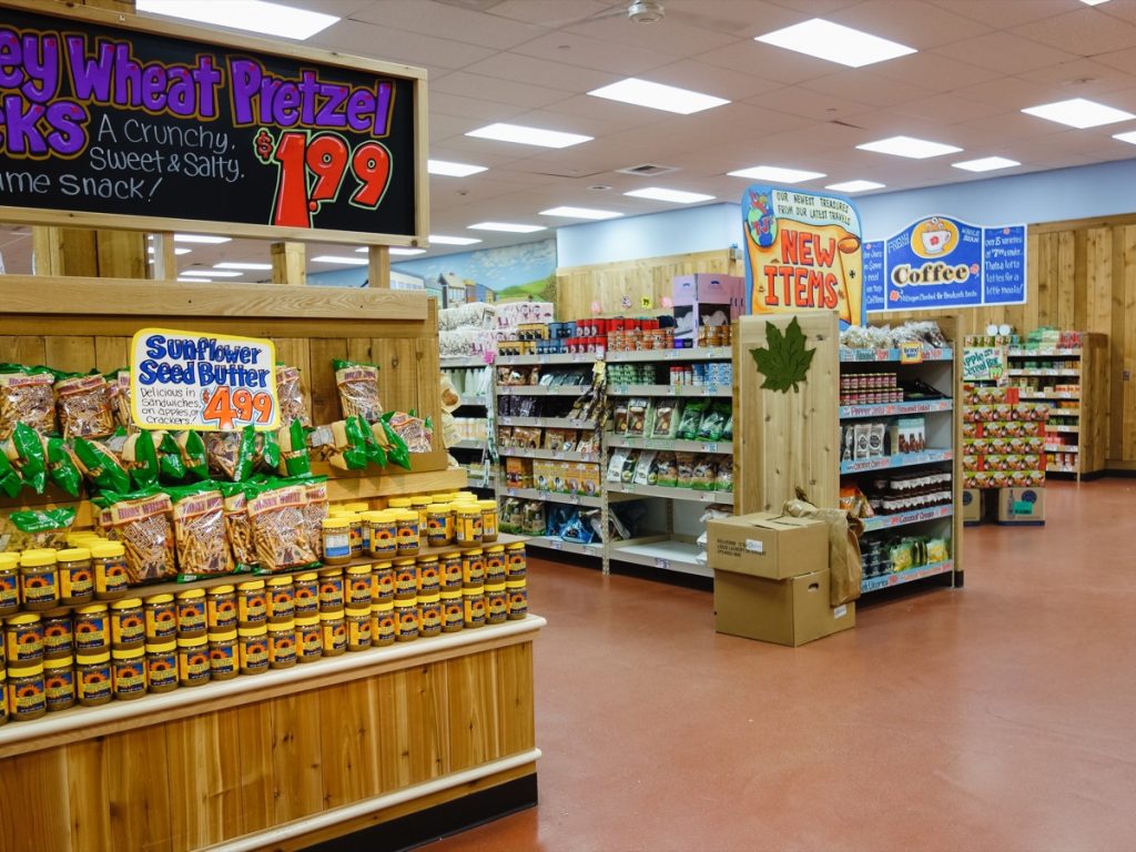 Shelves with products and ailes with special offers and new food items inside Trader Joe's grocery store, a American supermarket chain owned by German discount retailer Aldi