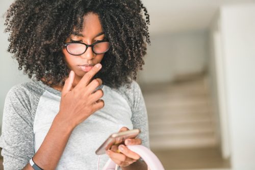 teenage girls using smartphone at home