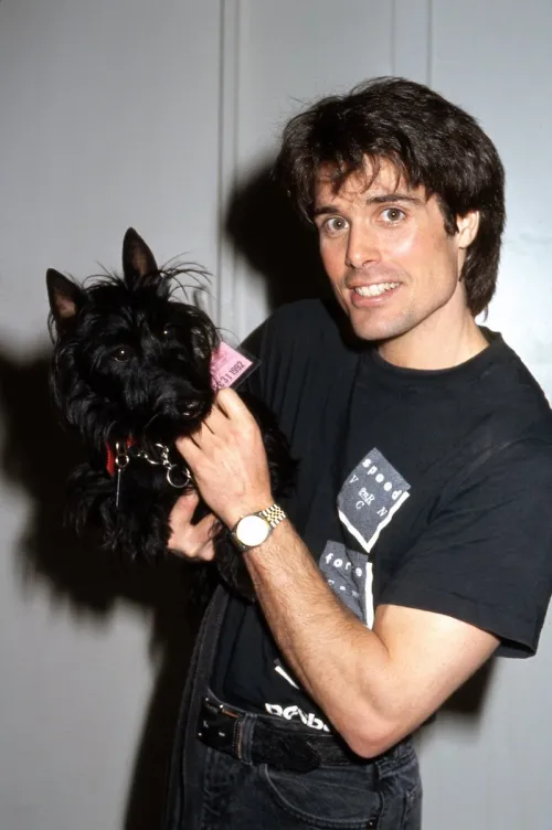 Peter Barton posing with a dog in 1991