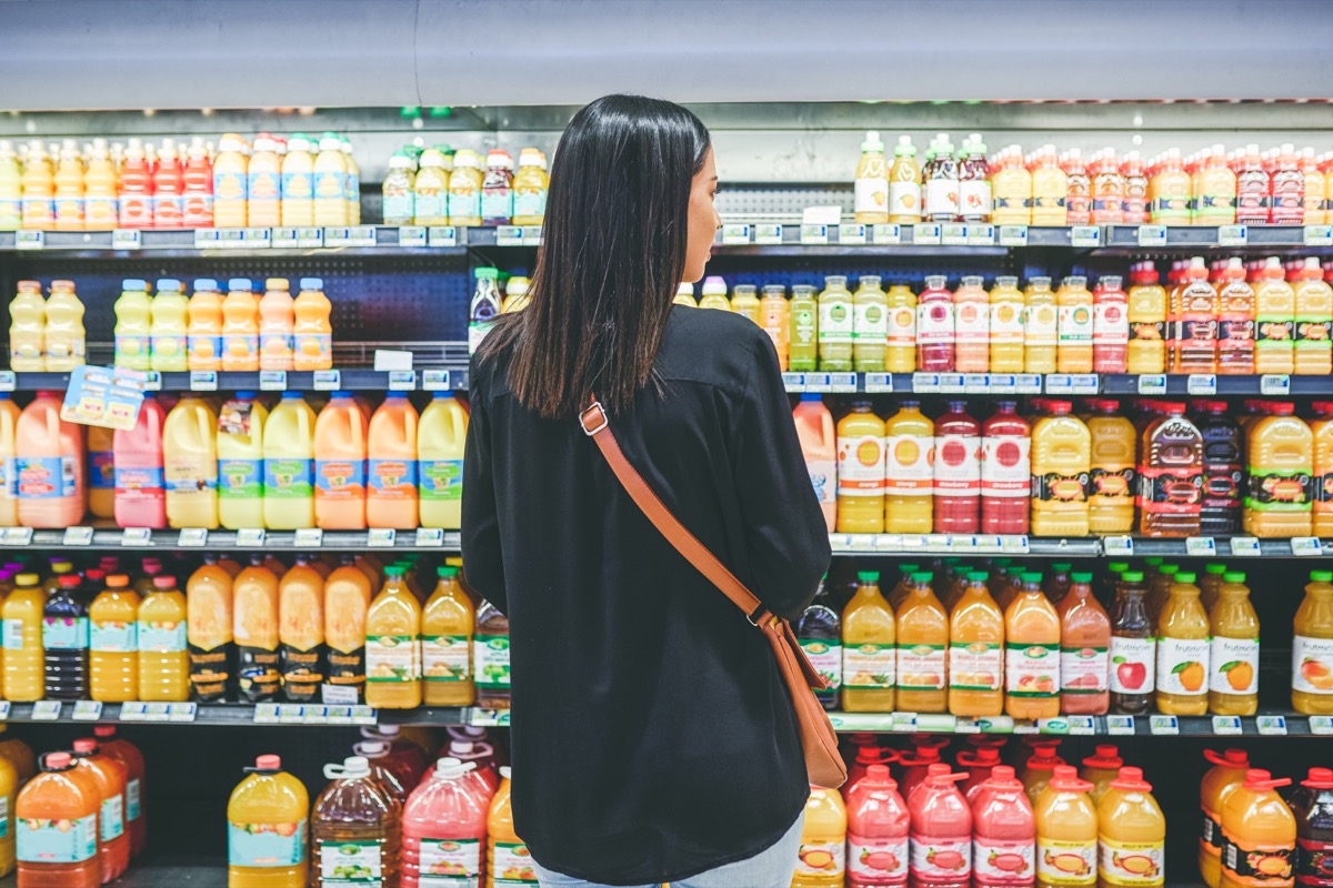 Rearview shot of a young woman shopping in a grocery store