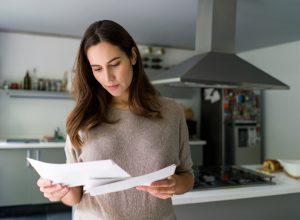 woman at home checking her mail - domestic life concepts