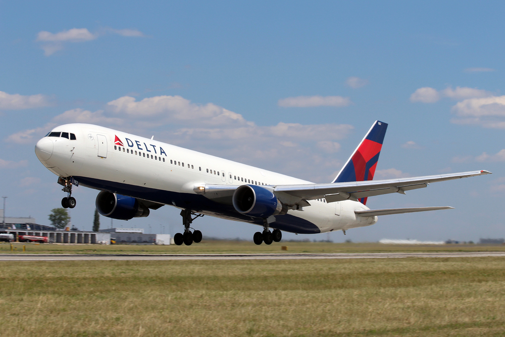 A Delta plane landing at an airport