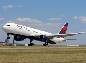 A Delta plane landing at an airport