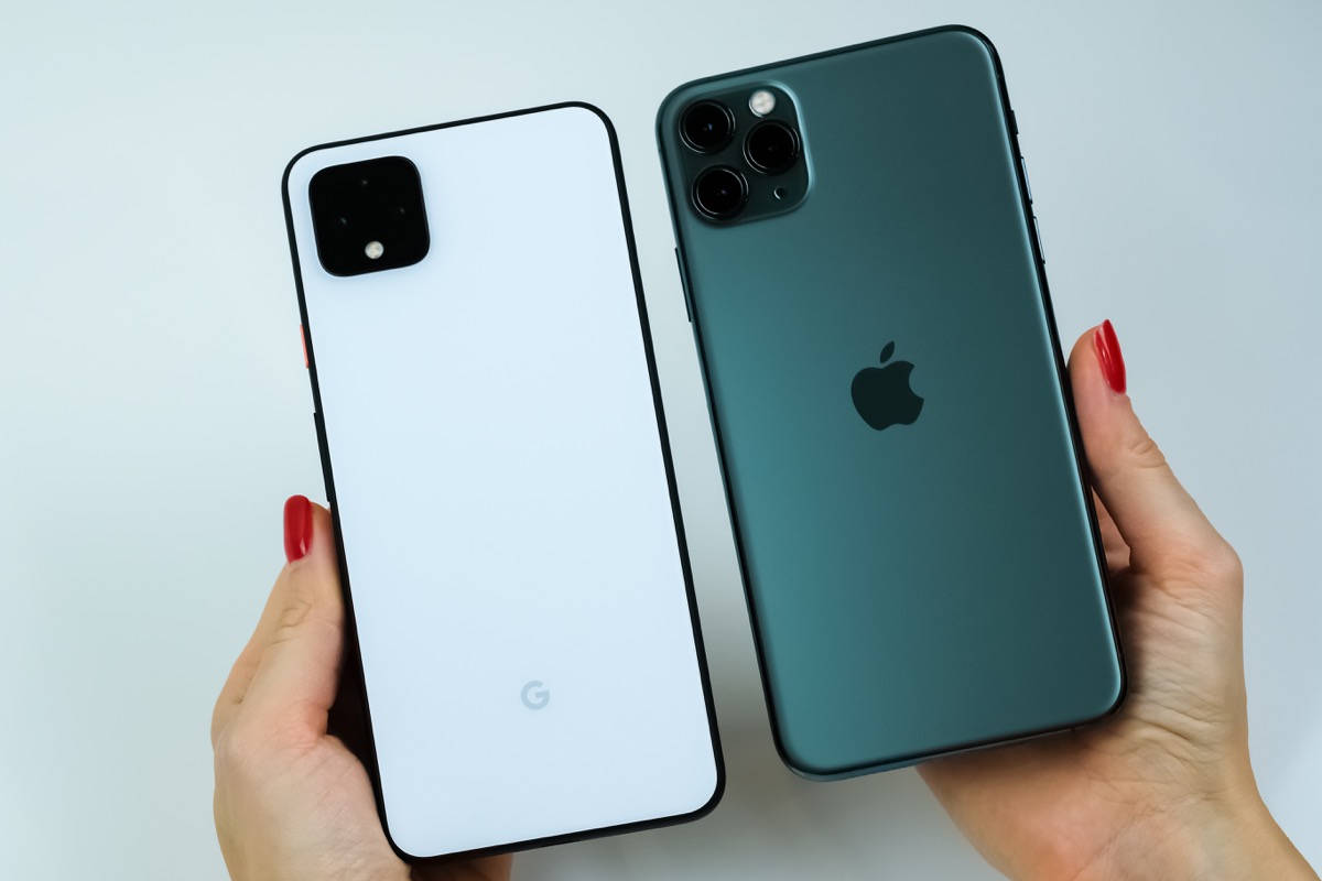Google Pixel 4 XL in clearly white color and iPhone 11 Pro Max in midnight green being held by a customer. Manhattan, New York, USA, October 24, 2019.