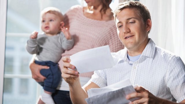 Mother and baby, father paying bills