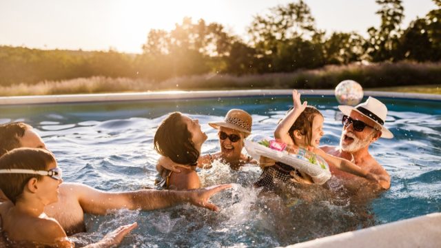 family having fun during summer day in the pool.