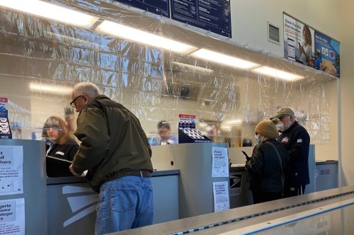 Plastic divider separating employees and customers at a local post office during the Coronavirus pandemic