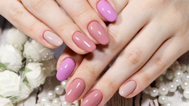 close up of perfect manicure with different pink nails