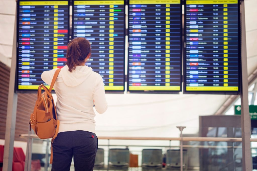 woman looking at flight schedules