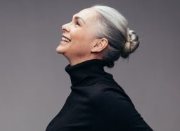 profile of smilling woman with gray hair pulled back