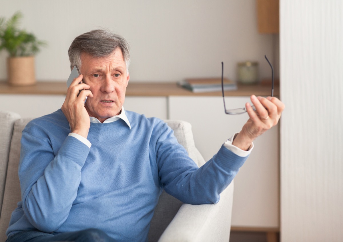 older man filing complaint on phone