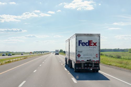 fedex delivery truck driving on road