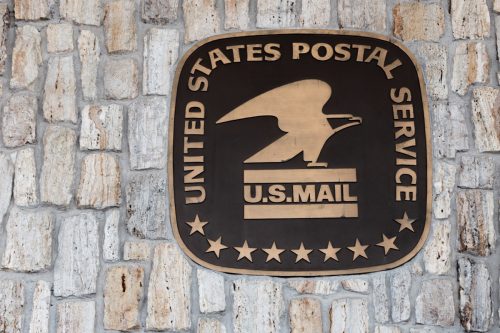 usps sign and logo on a wall