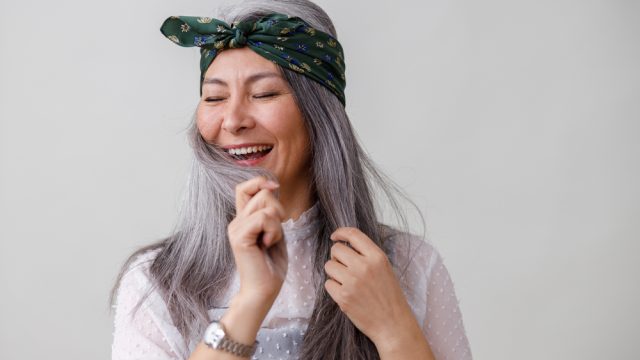 woman touching gray hair