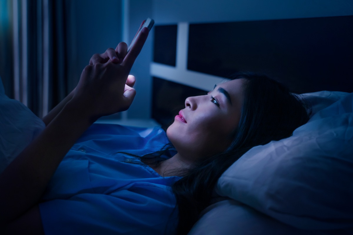 Woman Using Her Phone in Bed