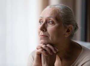 older woman looking out the window