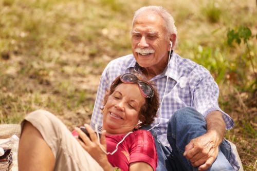 ζευγάρι ηλικιωμένων κάθεται και ακούει μουσική σε ένα MP3 player