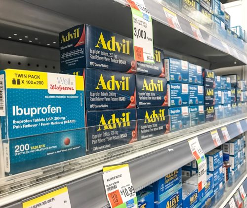 Advil and ibuprofen are on the pharmacy shelf