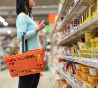 woman looking at grocery store shelves