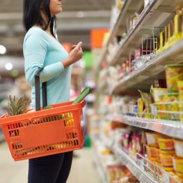 woman looking at grocery store shelves