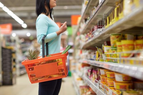 woman looking at grocery store shelves