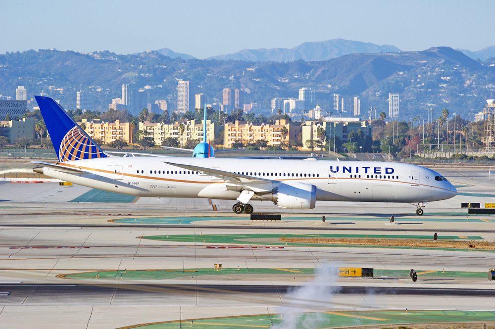 A United Airlines plane sitting on the runway at an airport