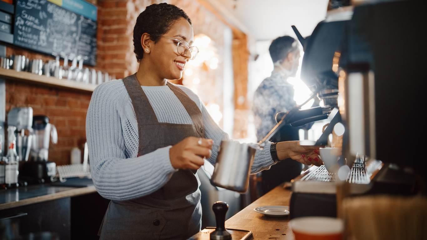 A barista making drinks at a coffee shop