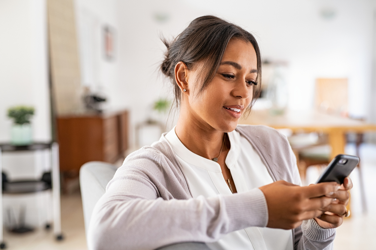 A young woman using an Apple iPhone