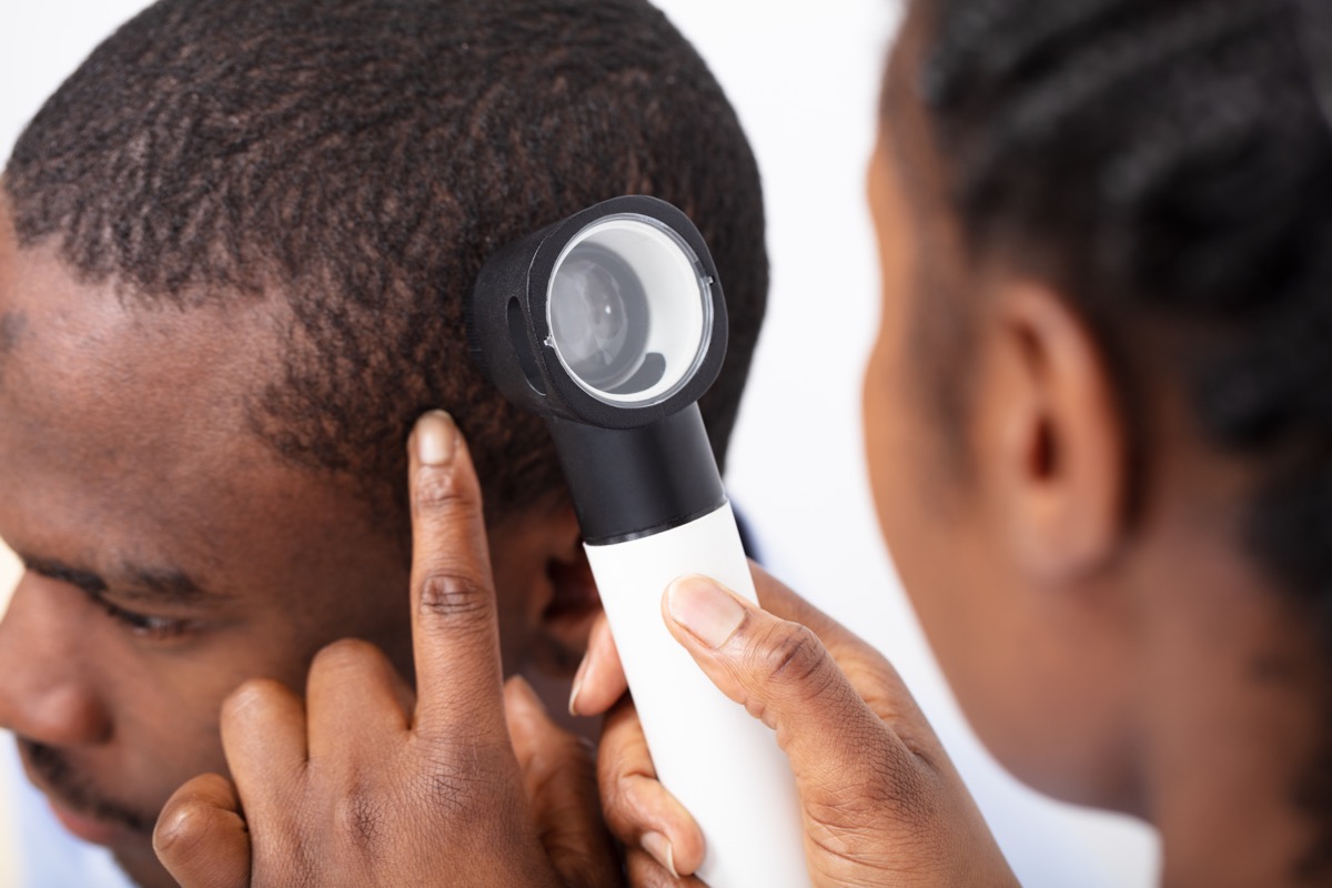 Black man being checked for skin cancer