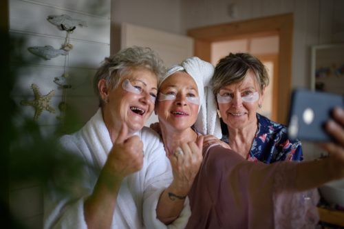 true friendship: senior women doing face masks 