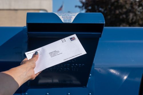 Mailing an application for ballot for 2020 election at a contactless drive-up mailbox at the US Post Office