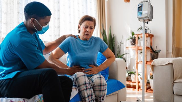 Abdominal pain patient woman having medical exam with doctor on illness from stomach cancer, irritable bowel syndrome, pelvic discomfort, Indigestion, Diarrhea, GERD (gastro-esophageal reflux disease)