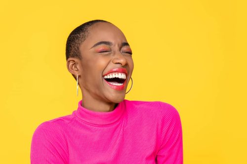 woman in pink shirt laughing