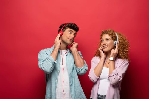 man and woman listening to music with headphones