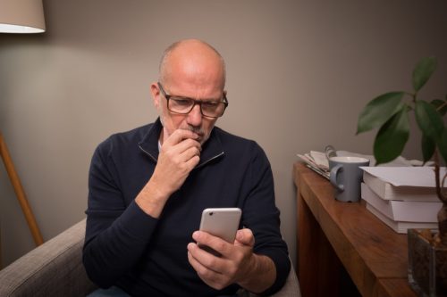 man looking worried at the phone