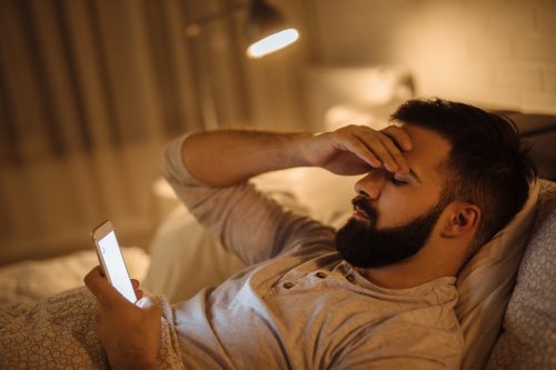 man looking concerned at smartphone