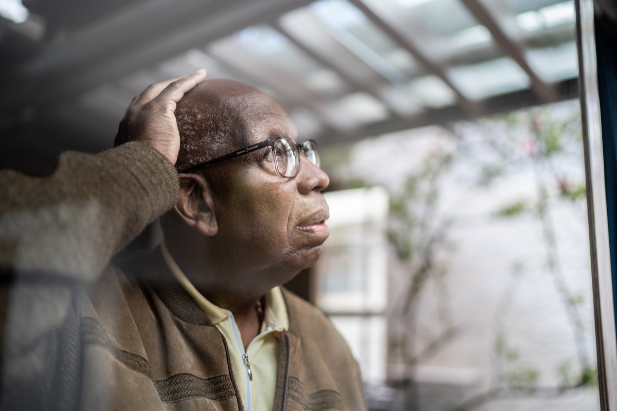 older man with dementiia looking out window