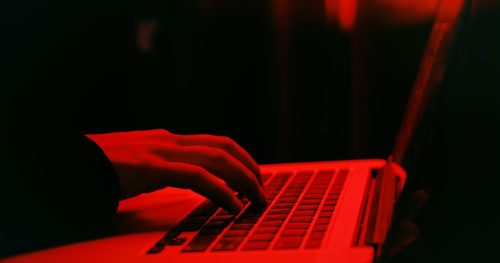 hacker using laptop computer