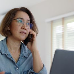 woman looking considered on phone