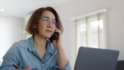 woman looking considered on phone